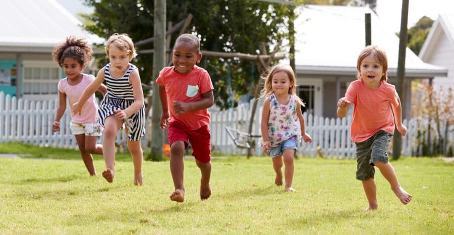 benefits of play-importance of play-unstructured play-five preschoolers running freely in the grass