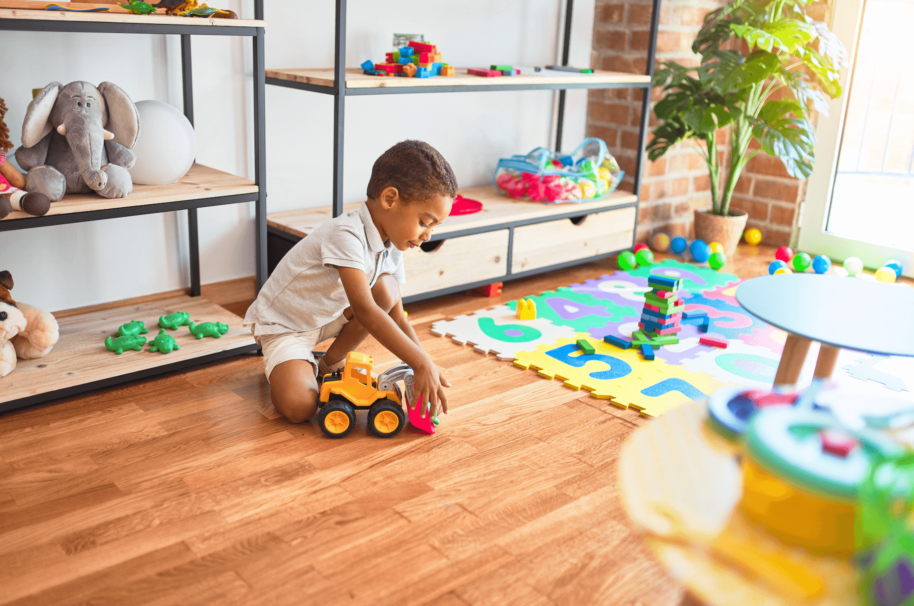 30 month old late talker playing as he waits for speech therapy