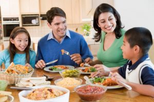 family of four having dinner together