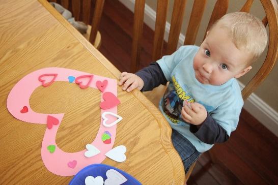 A baby sitting at a table

Description automatically generated with medium confidence