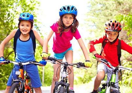 Photo image of children outside riding their bikes (Shutterstock image)