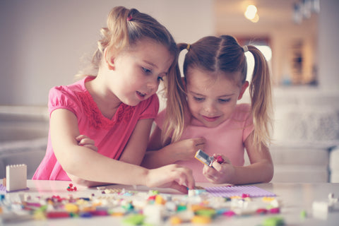 Two girls playing with Lego fine motor skills