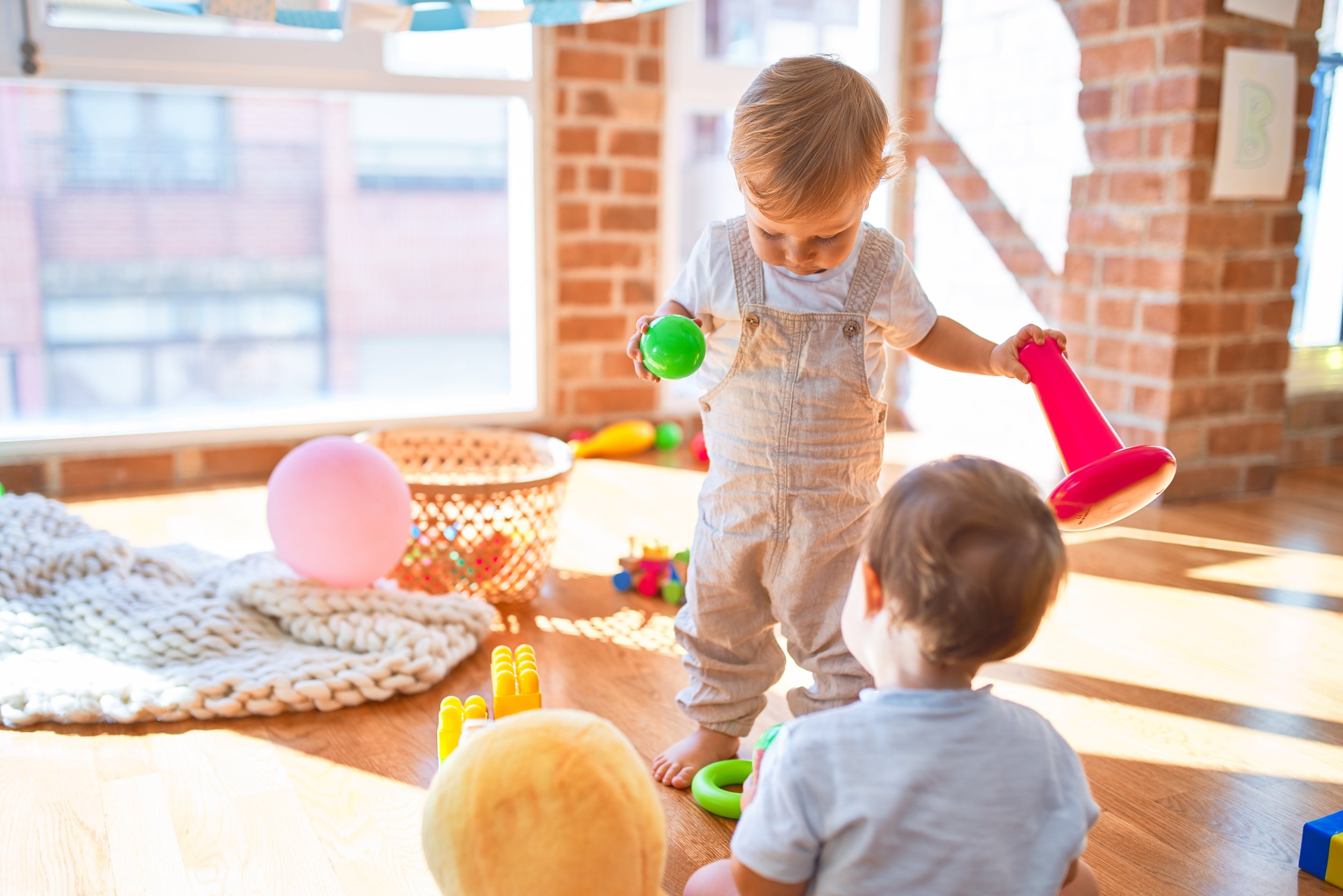 Little boy and girl playing ball together