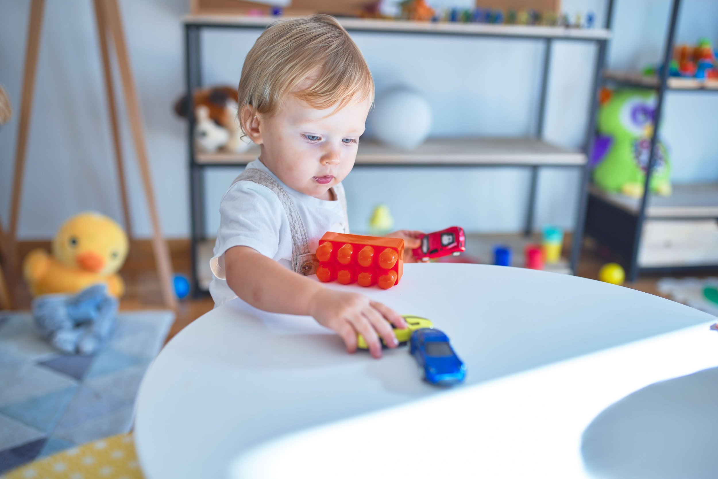 toddler boy playing with cars