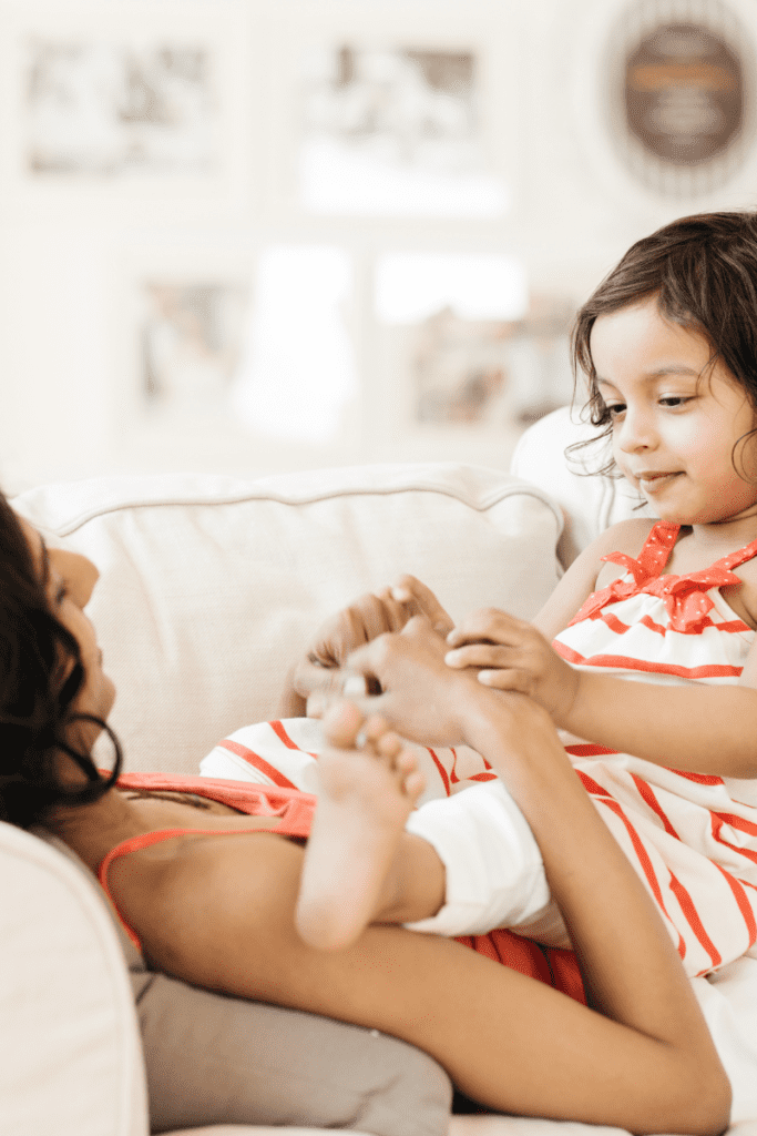 Toddler sitting on parent's lap and talking during a language activity.