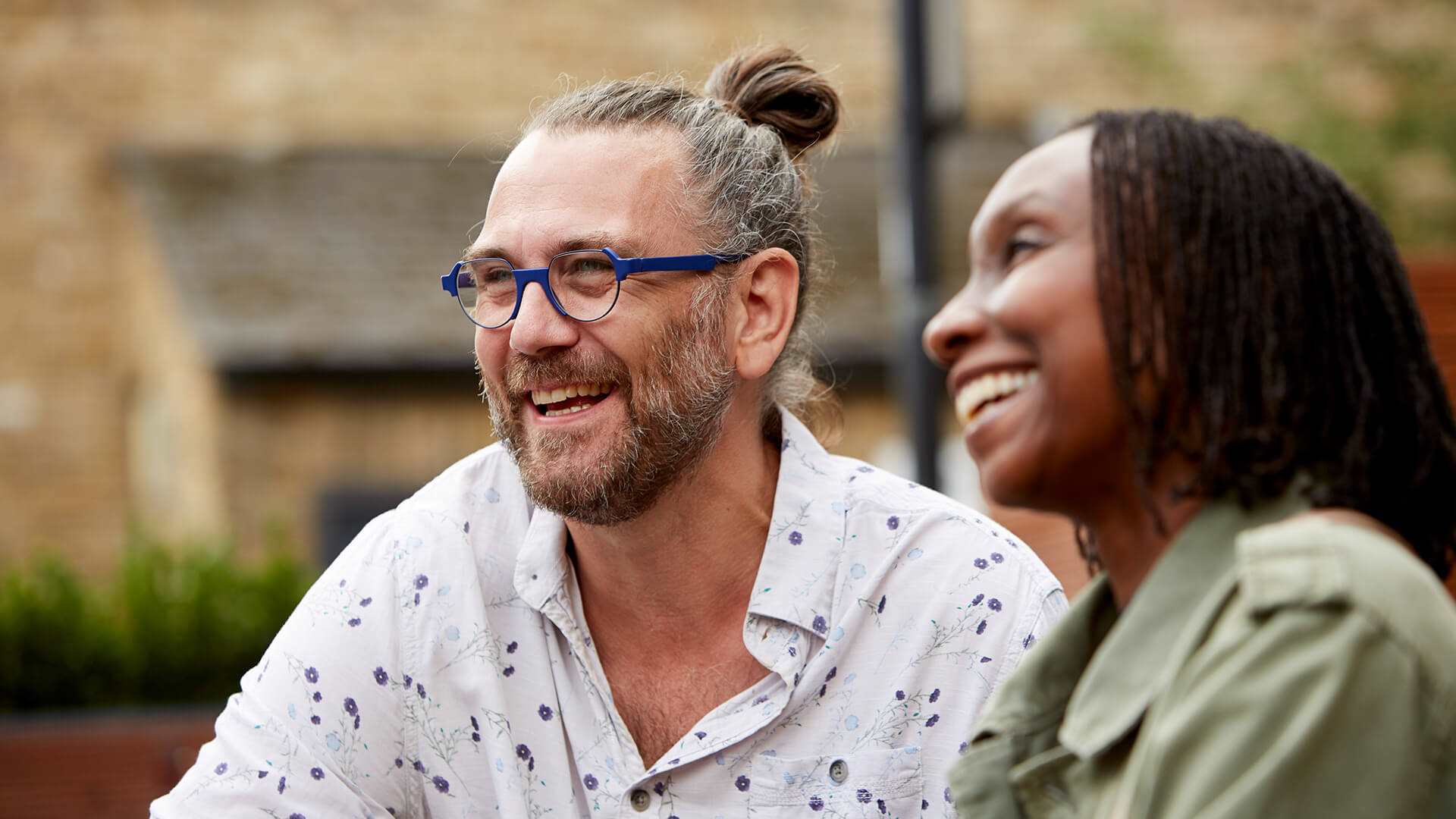 A happy couple laughing together outdoors