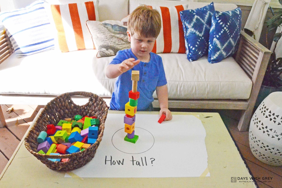 boy in blue playing with toys